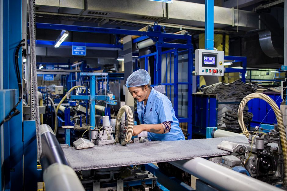 Worker operating a manufacturing machine