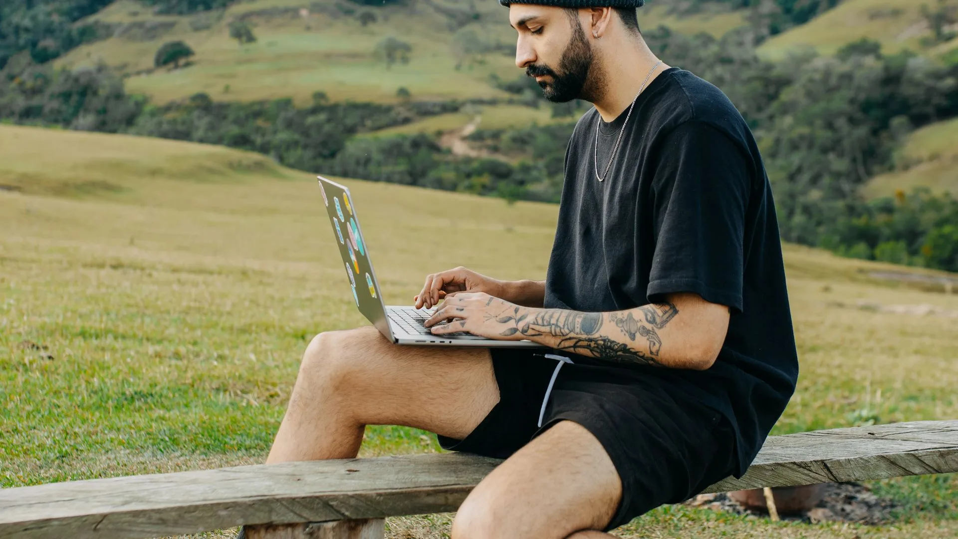 Remote worker using a laptop in the mountains while planning a move to Slovenia